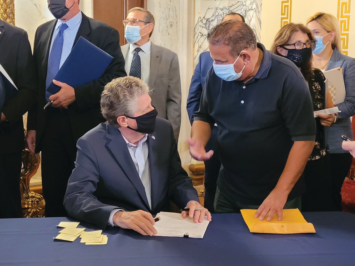 BILL SIGNED: Cranston resident and Johnston native Lou Massemini wanted the governor’s signature on his own copy of the bill. After the bill signing, he approached him, and Gov. Dan McKee offered his autograph one more time.